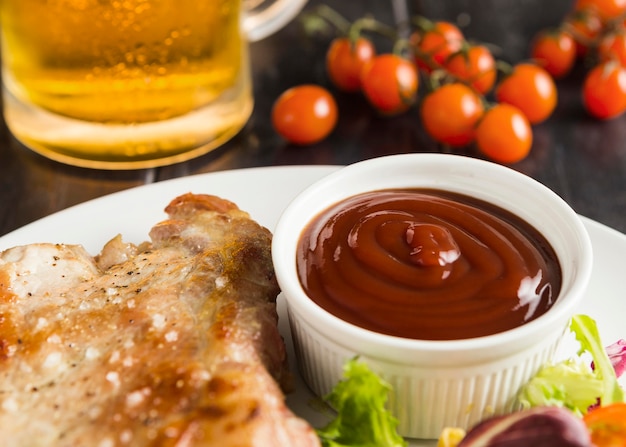 Free photo high angle of steak on plate with ketchup and beer