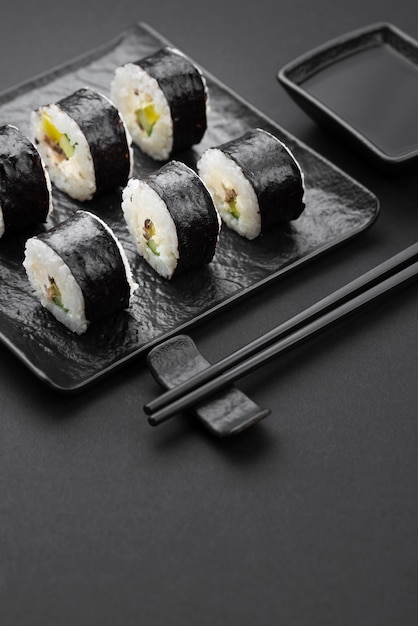 Free Photo high angle of sushi rolls with chopsticks and sauce