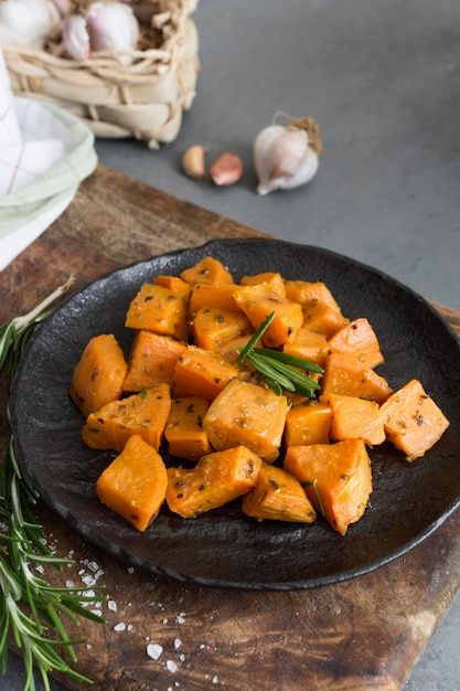 Free Photo high angle sweet potatoes on black plate