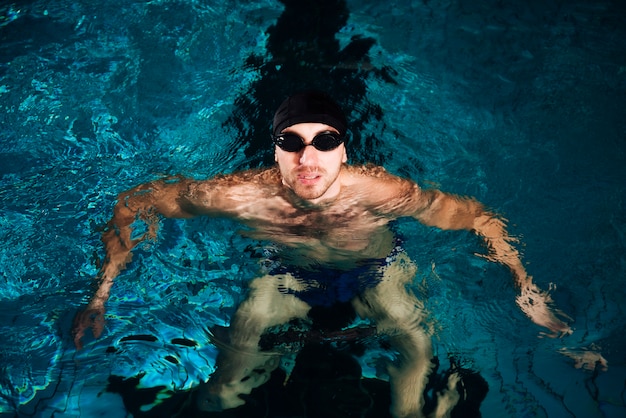 High angle swimming man in basin