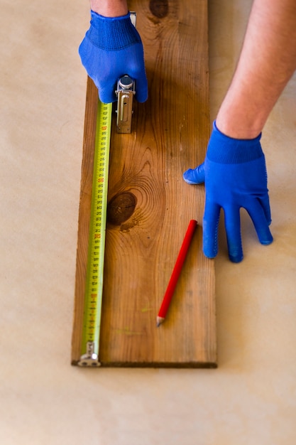 Free photo high angle of tape measure on wood