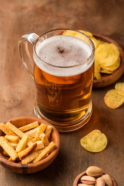 High angle tasty beer mug and chips