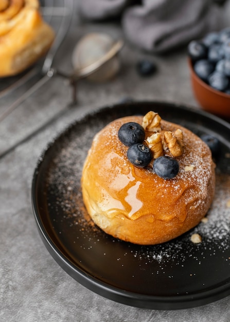 High angle tasty cinnamon roll with fruits