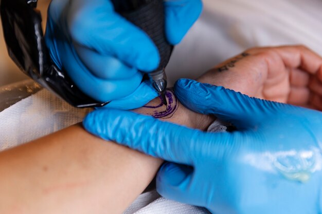 High angle tattoo artist doing their job