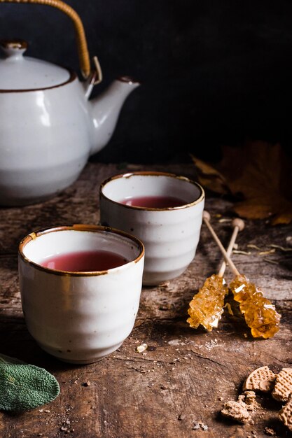 High angle tea in cups with crystallized sugar