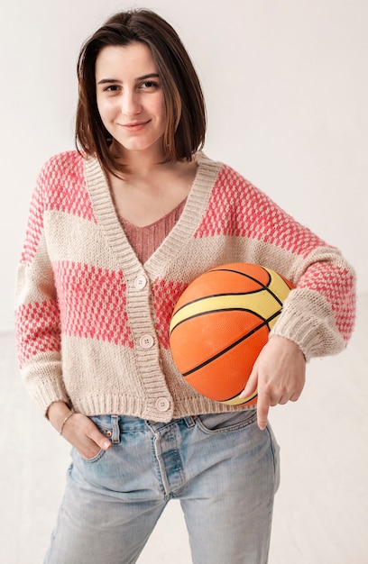 High angle teenage girl holding basketball ball