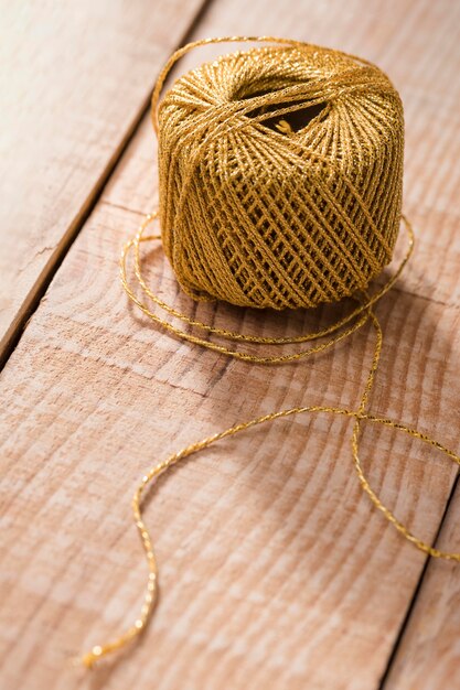 High angle of thread on wooden surface