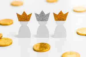 Free photo high angle of three paper kings with coins for epiphany day