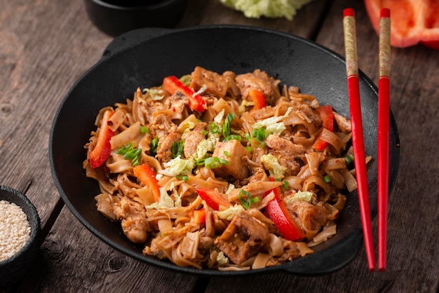 Free photo high angle of traditional asian dish with chopsticks