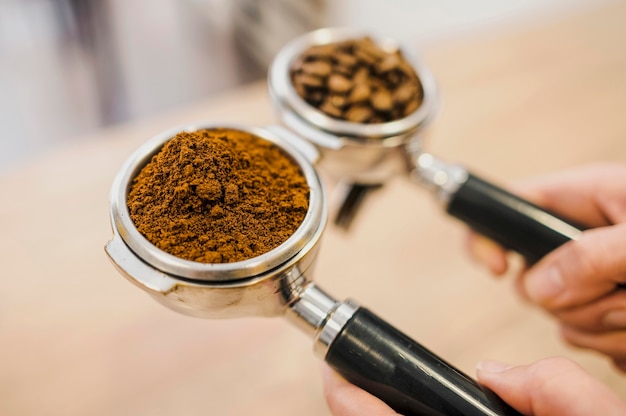 High angle of two coffee machine cups held by barista