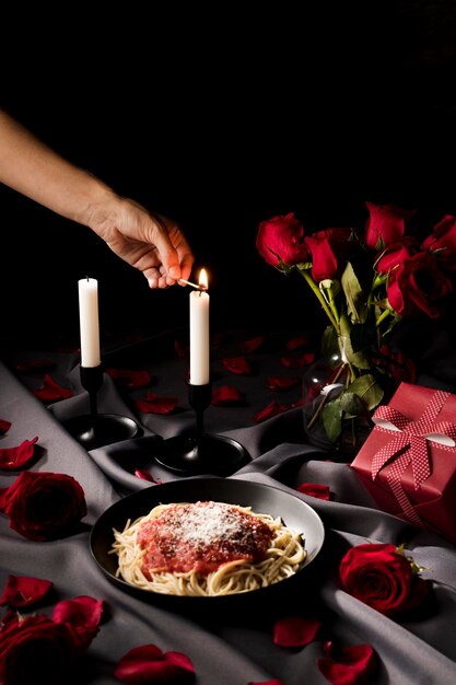 High angle of valentine's day table set with candles and pasta