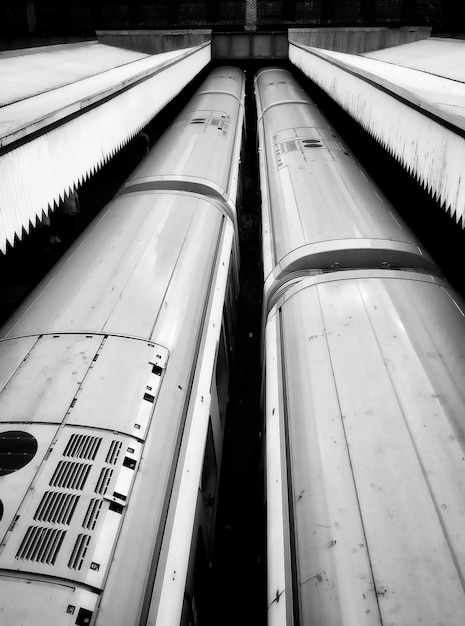 Free Photo high angle vertical shot of  two trains in a train station in black and white