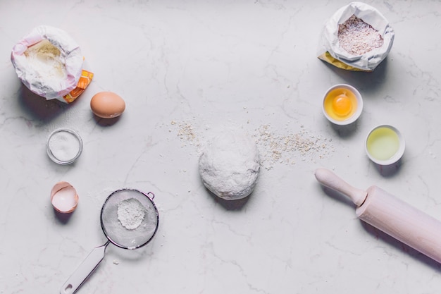 Free photo high angle view of baking ingredients and utensils on white background