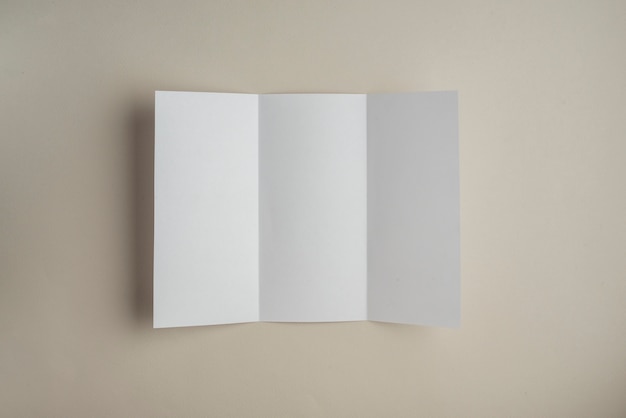 Free Photo high angle view of blank white paper on colored background