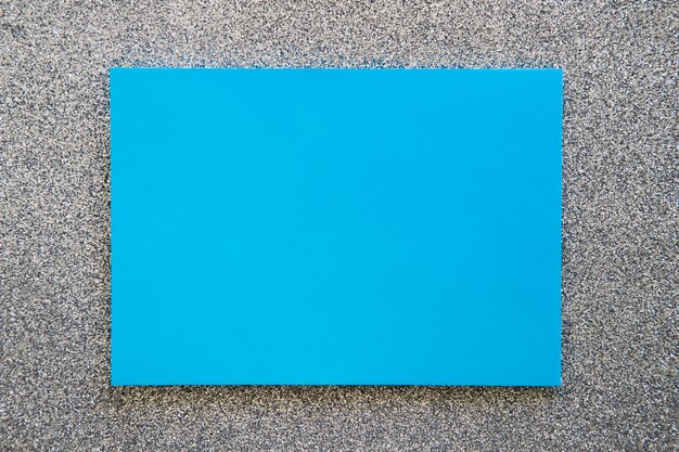 High angle view of blue cardboard paper on grey background