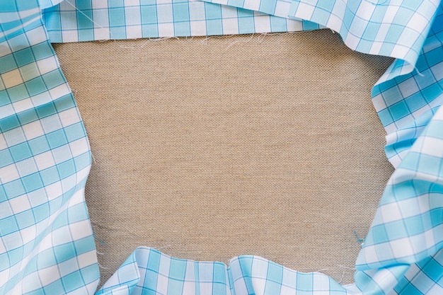 Free photo high angle view of blue chequered table cloth forming frame