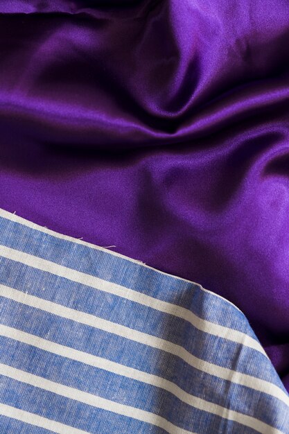 High angle view of blue plaid textile and smooth purple cloth