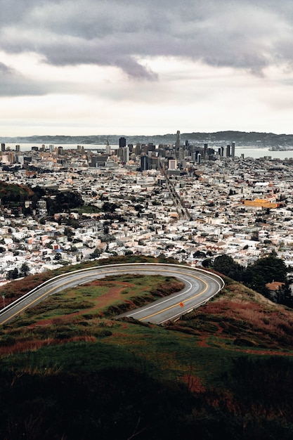 High-angle view of city buildings and gray pavement road