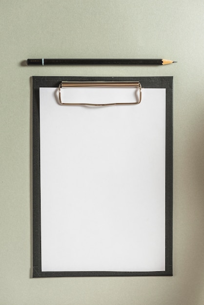 Free Photo high angle view of clipboard with blank white paper and pencil