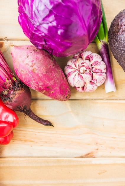 High angle view of colorful fresh vegetables on wooden plank