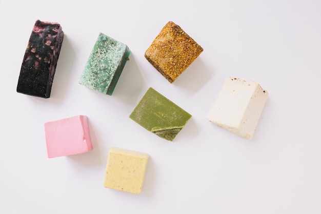 High angle view of colorful soap bars on white surface