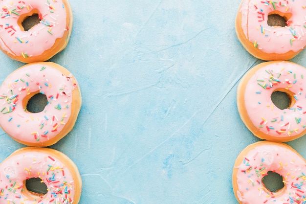 Free photo high angle view of delicious donuts on blue background