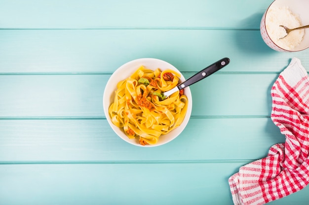 High angle view of delicious tagliatelle pasta over desk