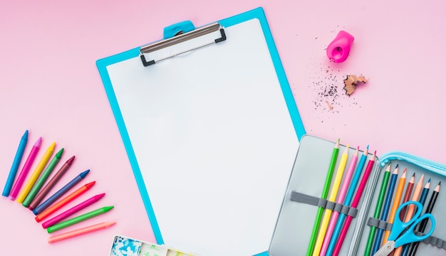 High angle view of drawing supplies on pink backdrop