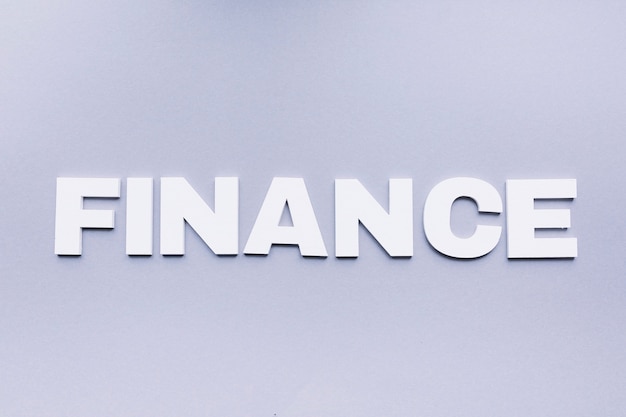 High angle view of finance word on grey background