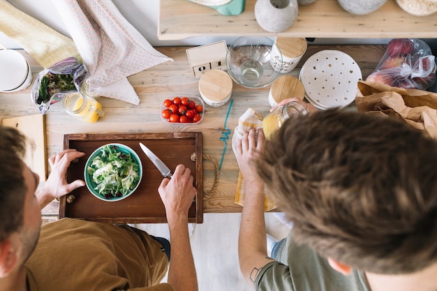 Free photo high angle view of friends making breakfast on kitchen counter