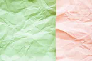 Free photo high angle view of green and pink crumpled paper surface