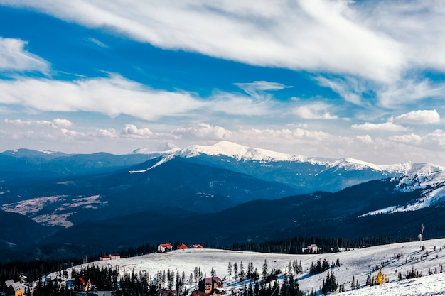 Free photo high angle view of houses over the snowy mountain landscape