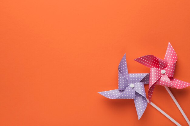 High angle view of polka dotted pinwheel on orange backdrop