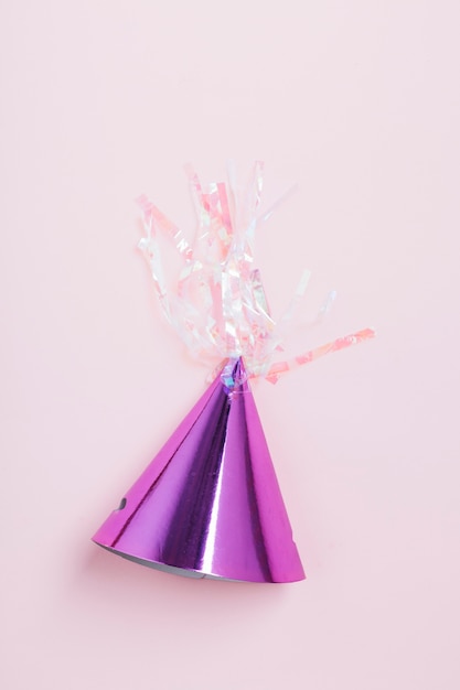 High angle view purple party hat on pink background