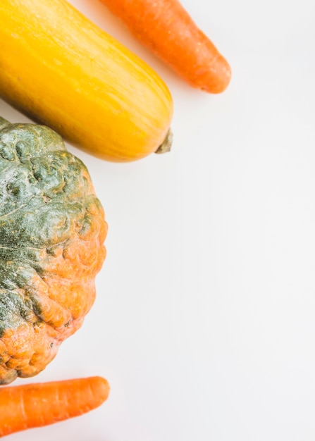 Free Photo high angle view of squash and carrots on white surface