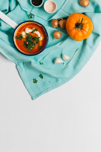 Free Photo high angle view of tomato soup with garlic and onion on white backdrop