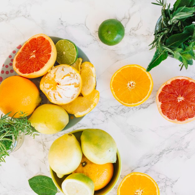 High angle view of various citrus fruits on marble