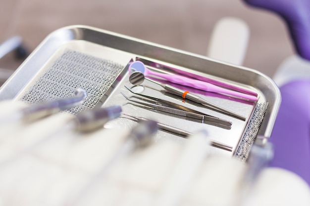 Free photo high angle view of various dental tools on tray