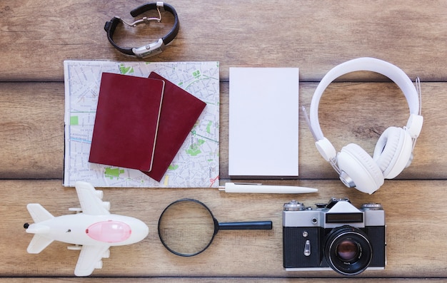 Free Photo high angle view of various traveler accessories on wooden backdrop