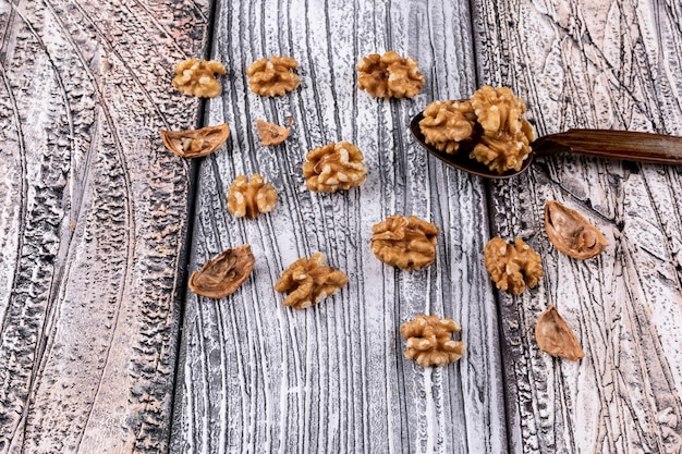 High angle view walnuts and wooden spoon on wooden horizontal