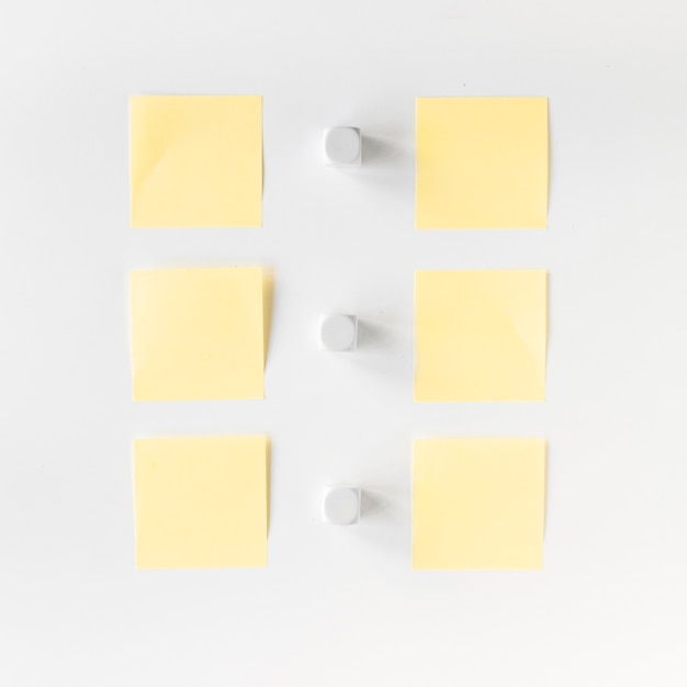 Free photo high angle view of white blocks and adhesive notes arranged in a row