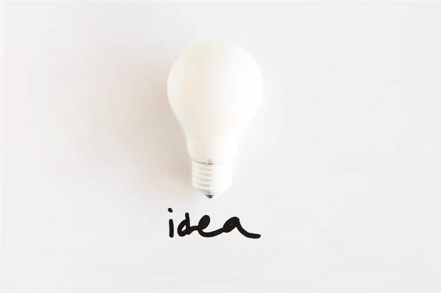 Free Photo high angle view of white bulb with idea word