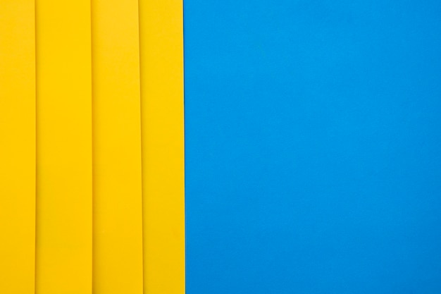 High angle view of yellow craftpapers on blue background