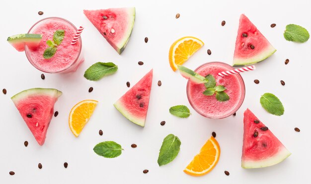 High angle of watermelon cocktail glasses with mint and straws