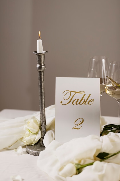 Free Photo high angle wedding table number with candle