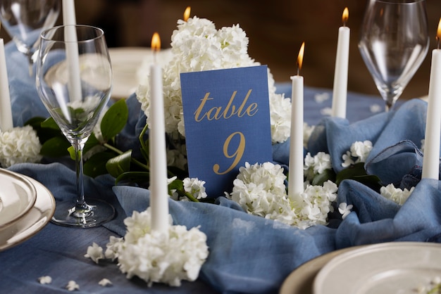 Free photo high angle wedding table number with flowers