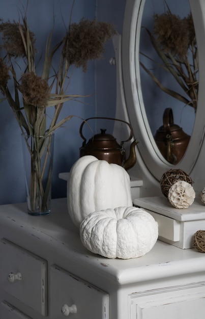 High angle white pumpkins on mirror table