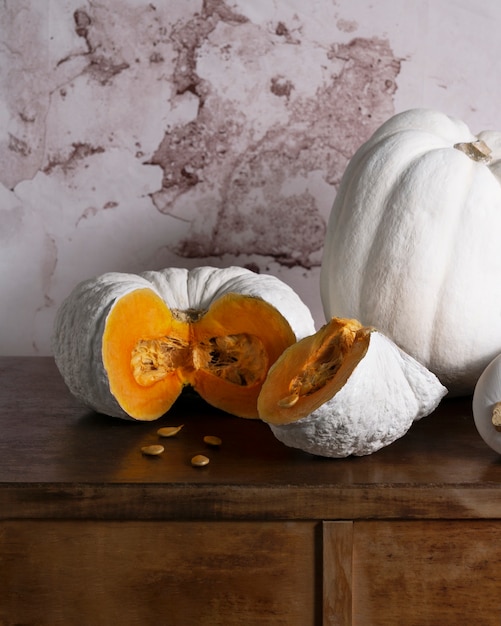 Free Photo high angle white pumpkins on table