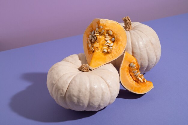 High angle white pumpkins with purple background