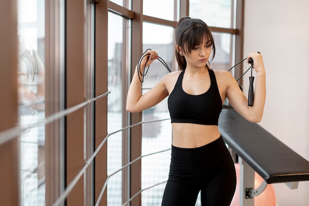 High angle woman on break with jumping rope